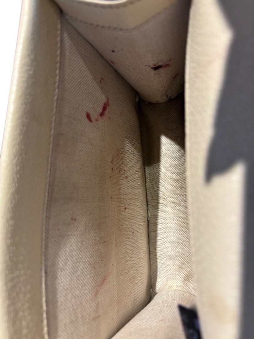 Posh Purse Co. cream leather Gucci Dionysus bag interior with red stains.