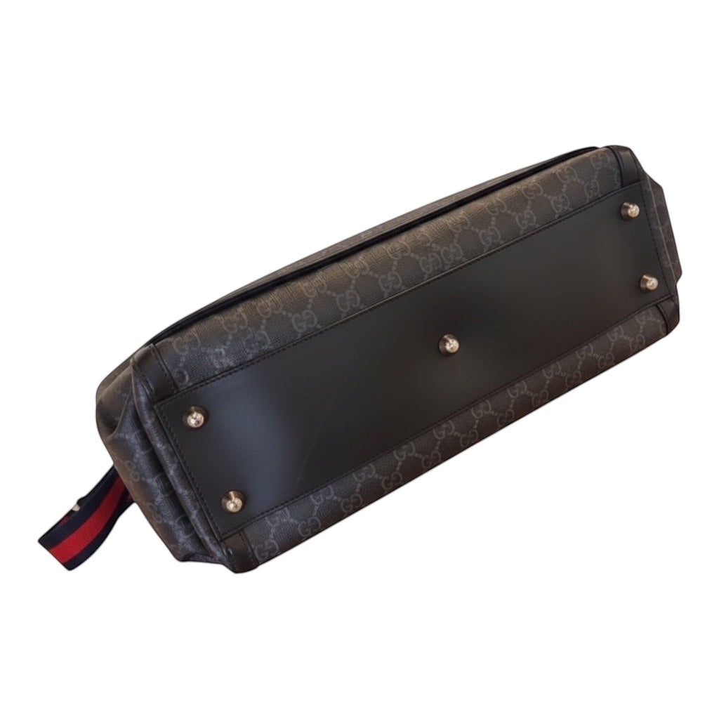 Posh Purse Co designer messenger bag in black GG canvas with leather trim and red/blue striped strap. Features exterior pockets and metal feet.