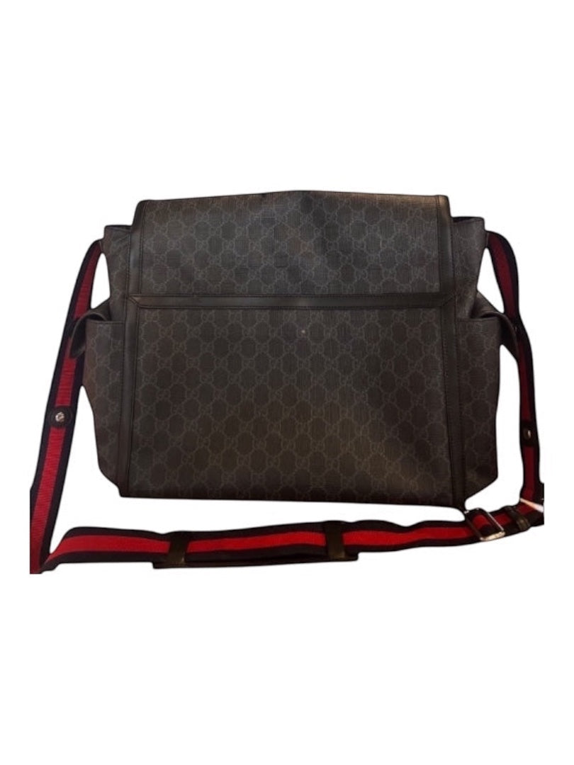 Posh Purse Co designer messenger bag in signature pattern canvas with leather trim and red/blue striped adjustable strap. Multiple exterior pockets.