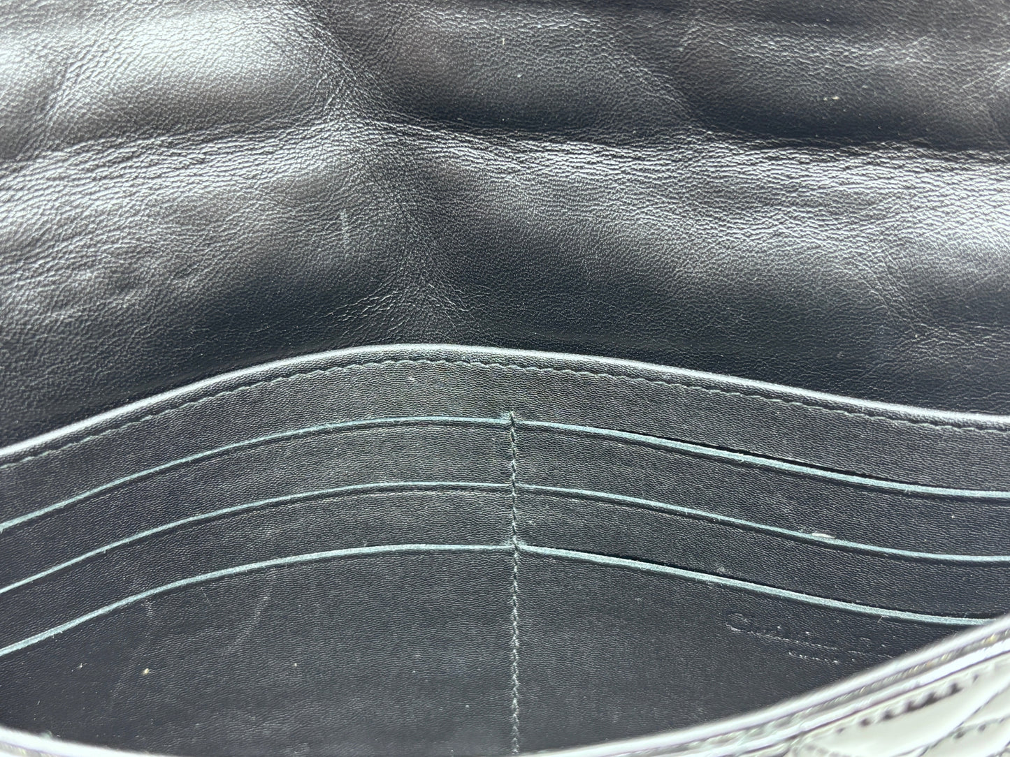 Interior of Posh Purse Co black patent leather Dior Cannage bag showing card slots and leather lining