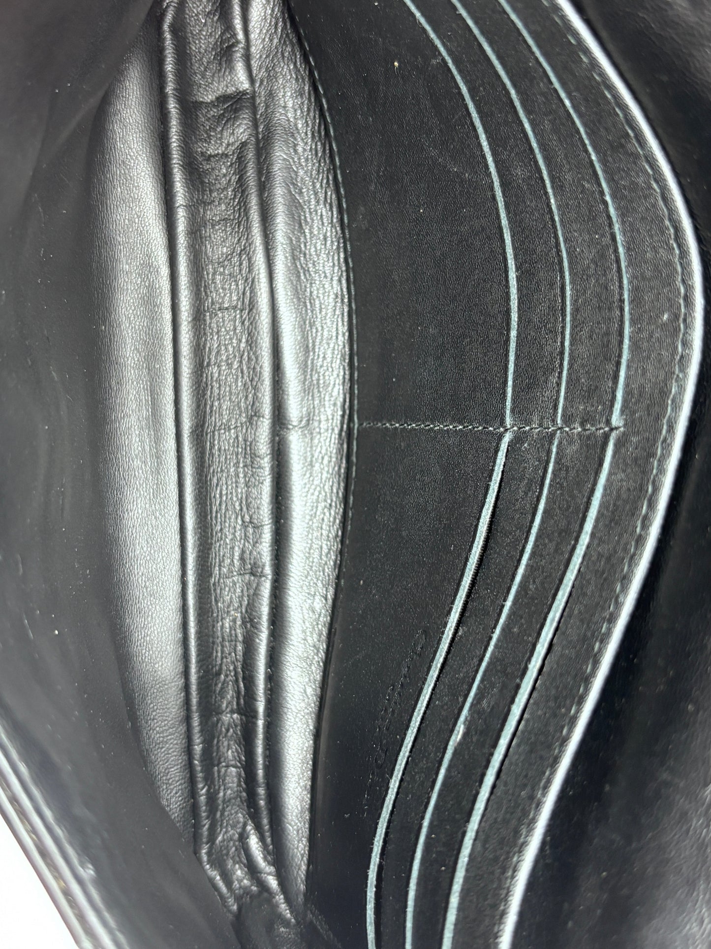Interior view of Posh Purse Co black Dior Cannage crossbody bag featuring leather card slots and a clean lining