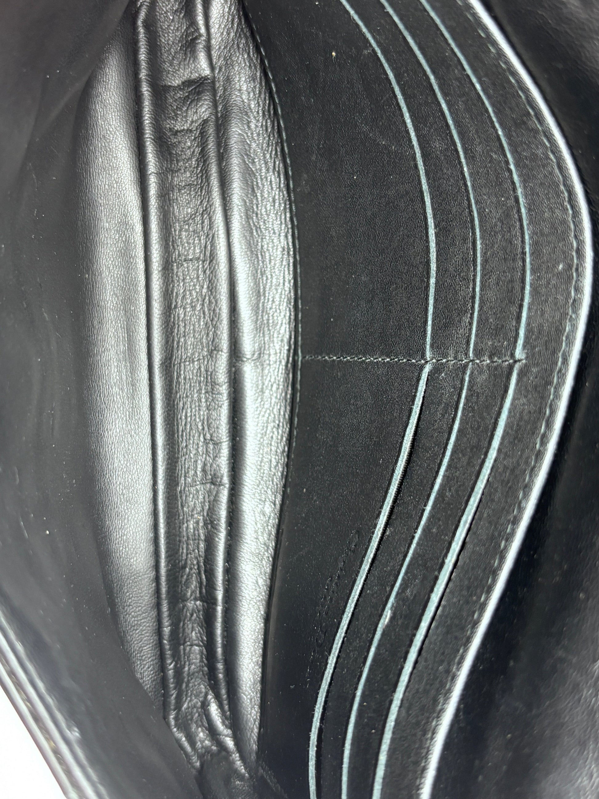 Interior view of Posh Purse Co black Dior Cannage crossbody bag featuring leather card slots and a clean lining