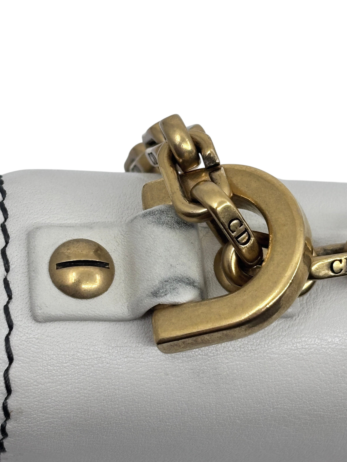Posh Purse Co ivory Dior J'Adior chain flap bag showing close-up of gold-tone hardware and leather strap attachment
