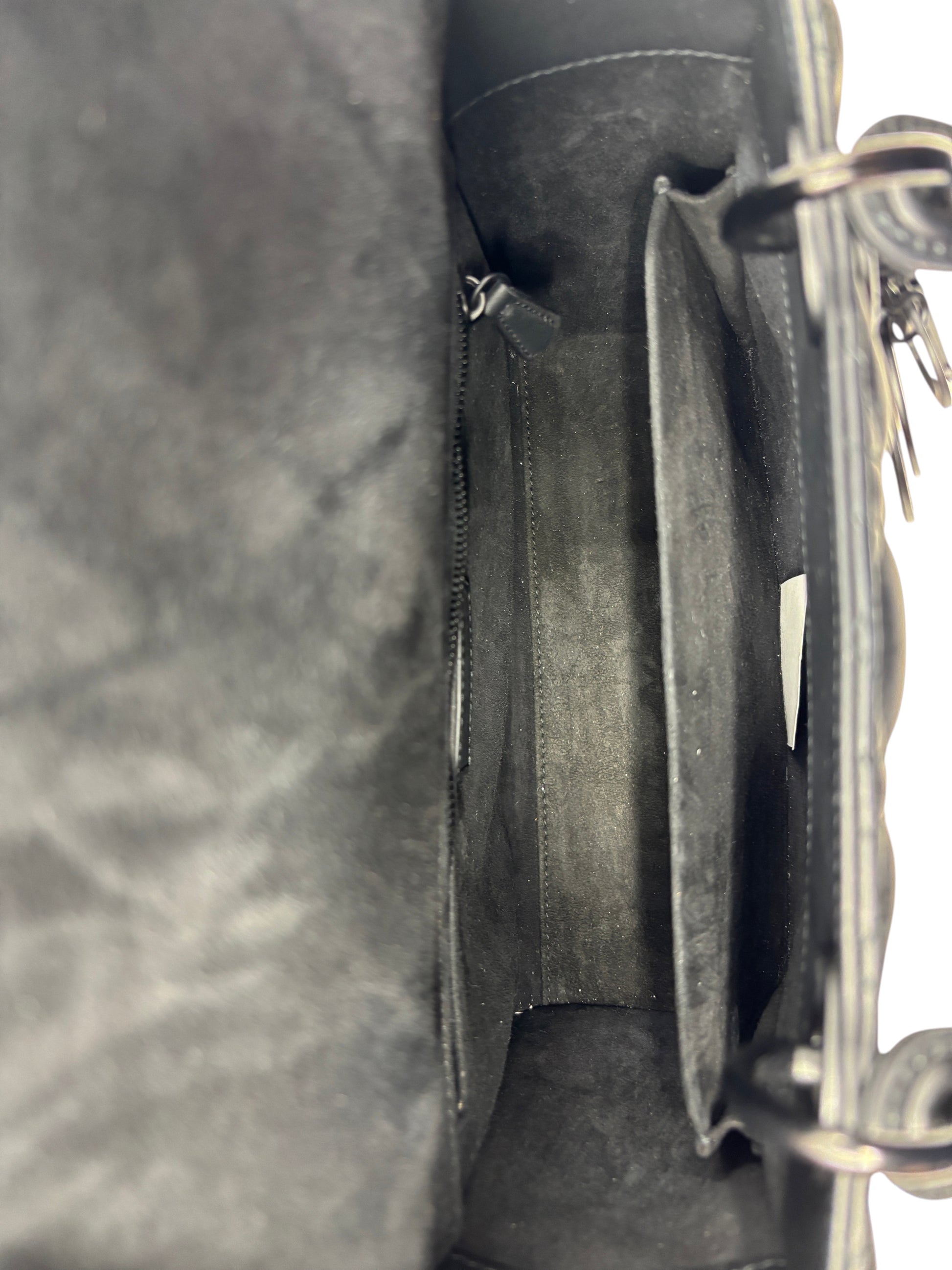 Interior view of a Posh Purse Co. preloved Dior Lady Dior medium bag featuring a spacious matte black suede lining.