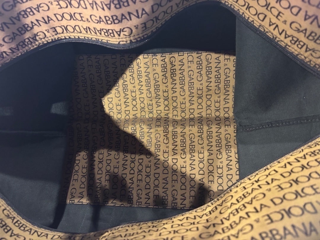 Posh Purse Co Dolce & Gabbana canvas duffel bag with all-over logo print interior and exterior. Spacious for travel.
