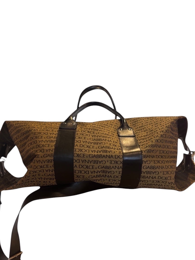 Posh Purse Co Dolce & Gabbana brown canvas weekend duffel bag with all-over logo print and dark brown leather trim and handles.