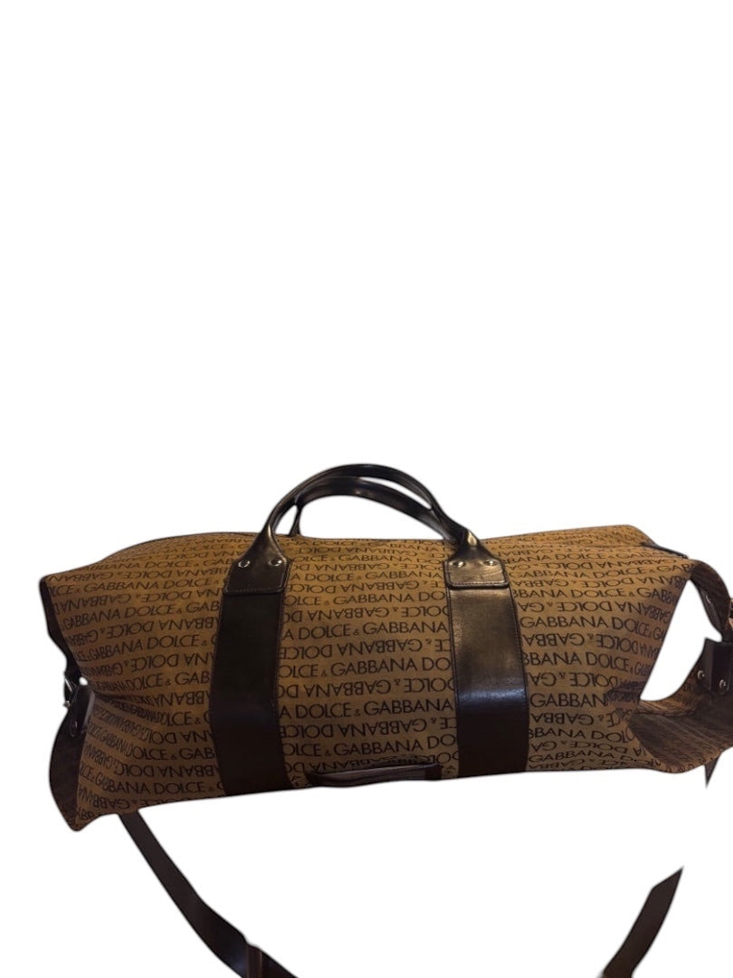 Posh Purse Co Dolce & Gabbana brown canvas weekend duffel bag with all-over logo print and dark brown leather trim and handles.