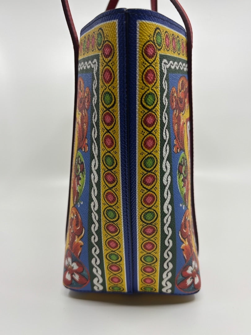 Posh Purse Co. Dolce & Gabbana Dauphine Escape tote bag with blue, yellow, red, and green ornate print. Leather handles.