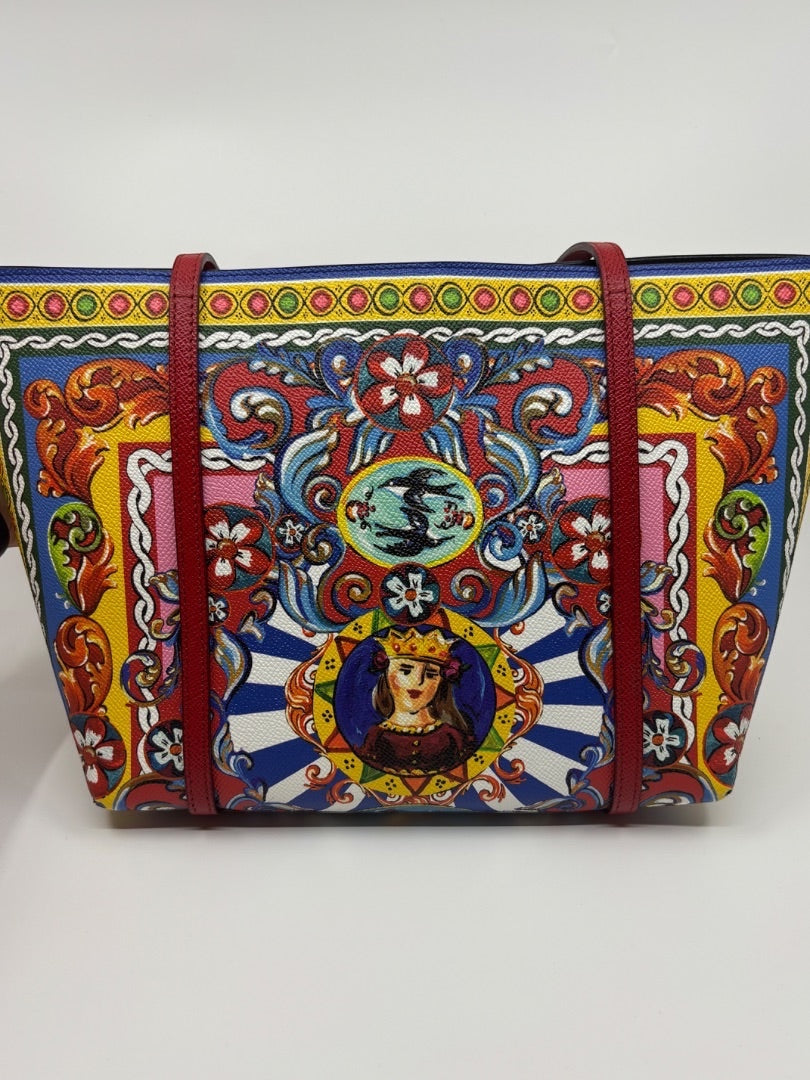 Dolce & Gabbana Dauphine Escape tote bag with red straps and a colorful baroque print featuring a portrait of a queen.