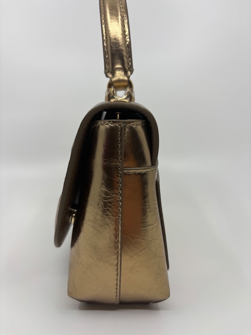 Posh Purse Co. Dolce & Gabbana small gold top handle bag with structured silhouette and polished hardware.