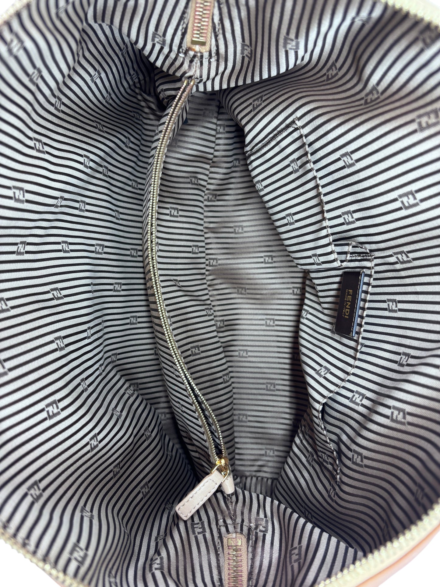 Interior of a Posh Purse Co preloved Fendi Chameleon satchel featuring striped fabric lining and Fendi logo tag.