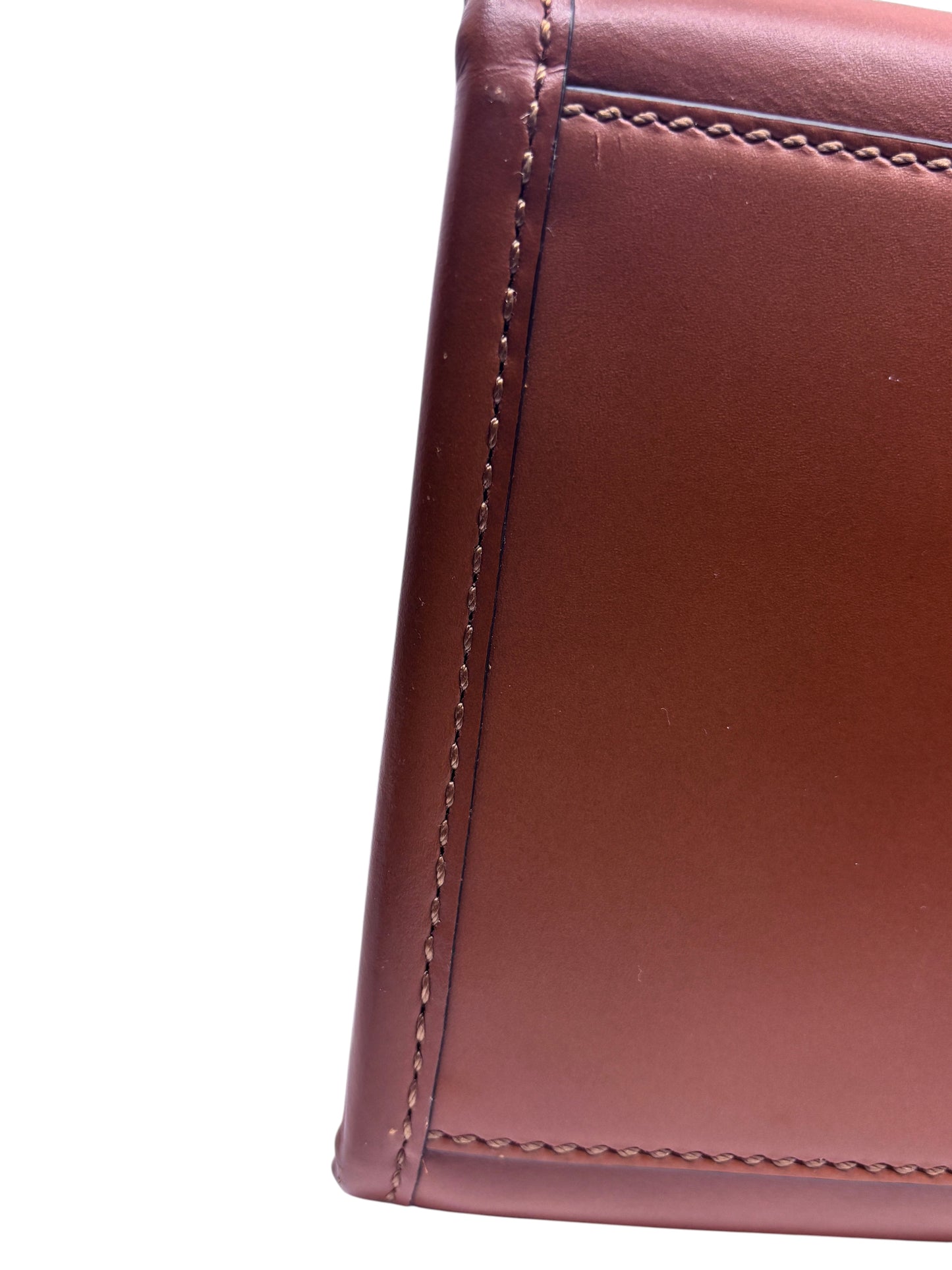 Close-up of the tan leather side panel and stitching on a Posh Purse Co Fendi Sunshine tote bag.