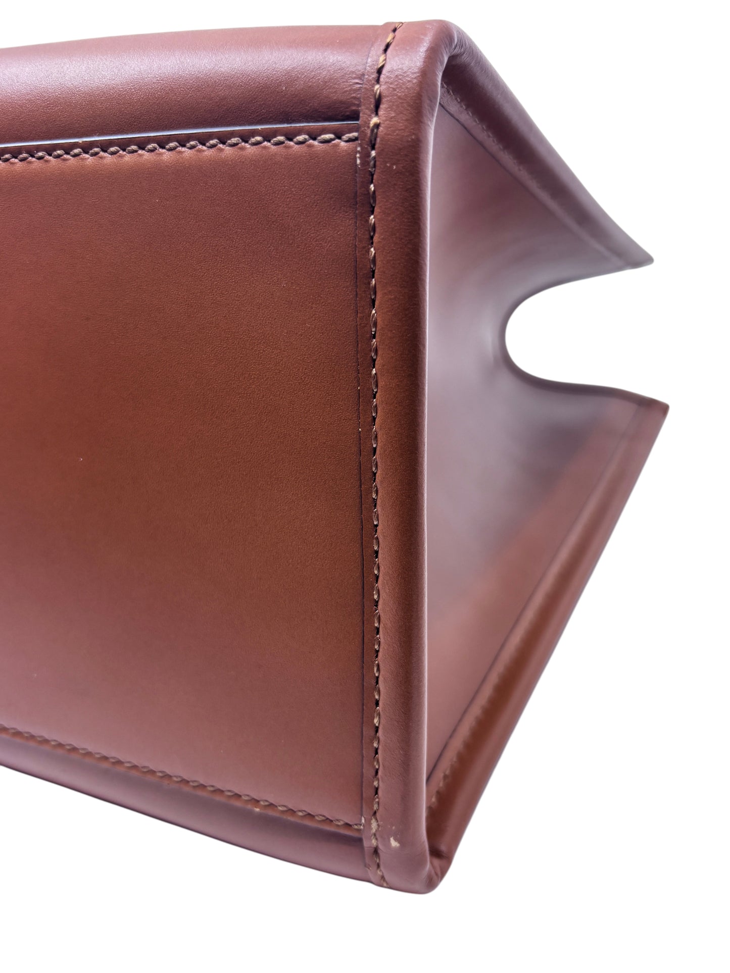 Close-up of the tan leather side panel and stitching detail on a Posh Purse Co Fendi Sunshine tote bag.