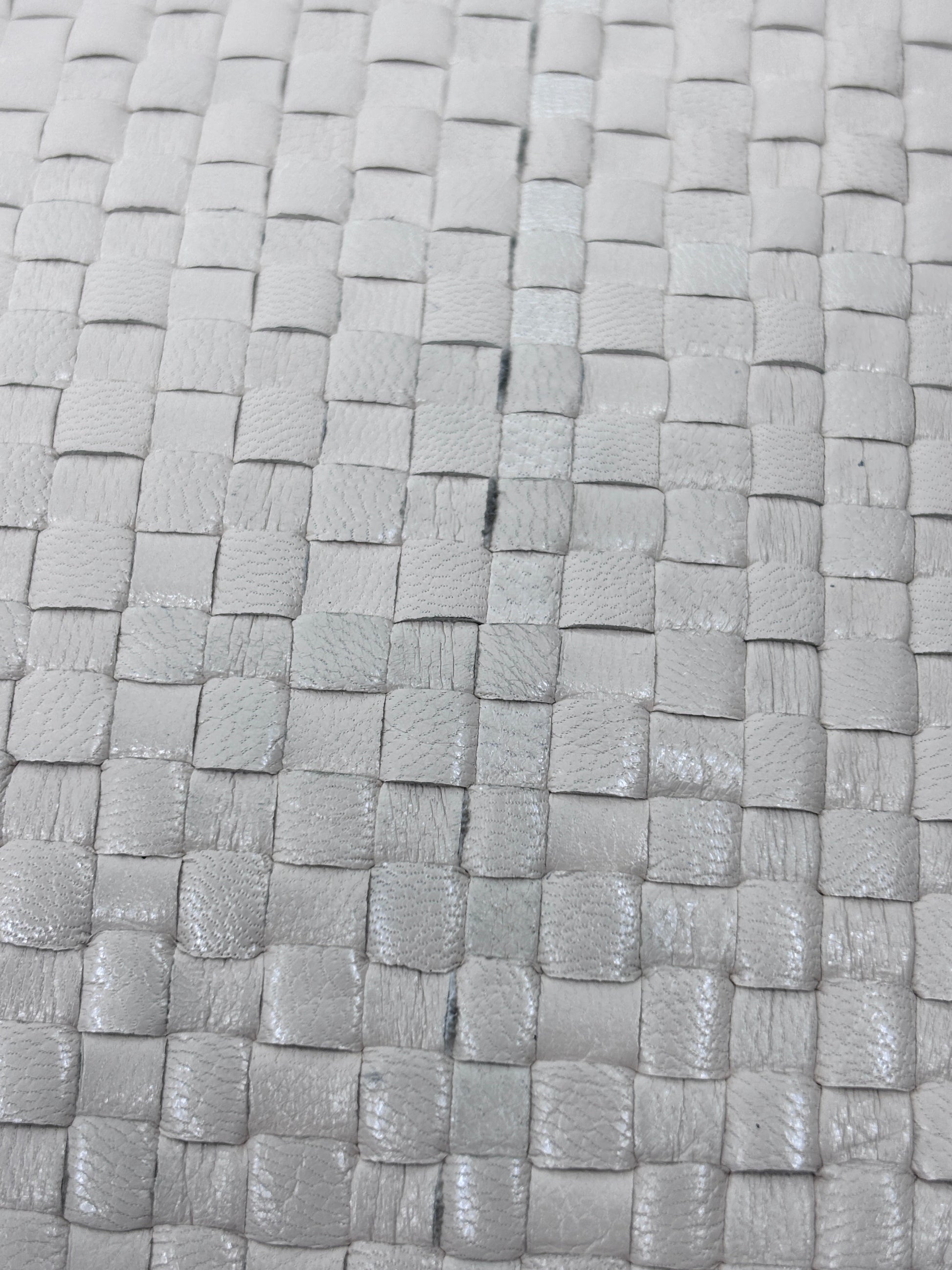 Close-up of the woven straw texture on a vintage Fendi crossbody bag from Posh Purse Co in a neutral beige tone.