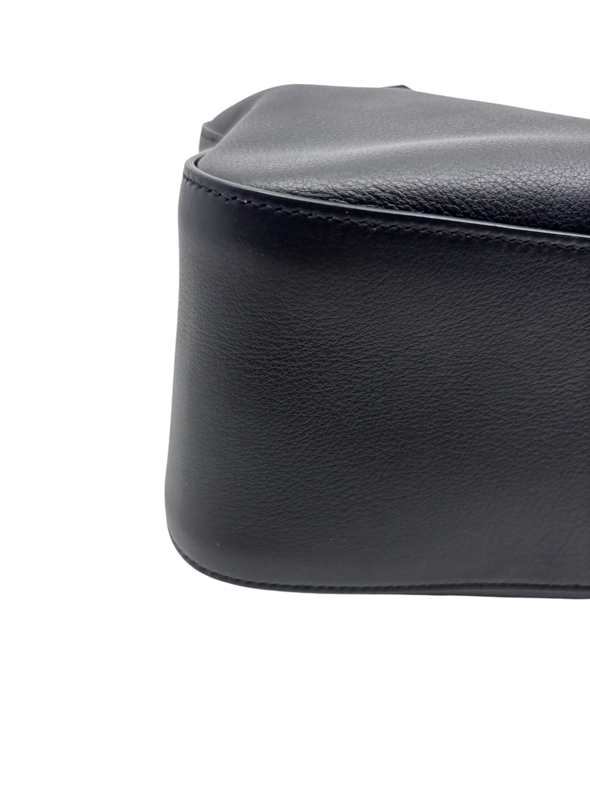 Close-up of the black leather side panel of a Posh Purse Co. Ferragamo triple zip handbag with smooth stitching.