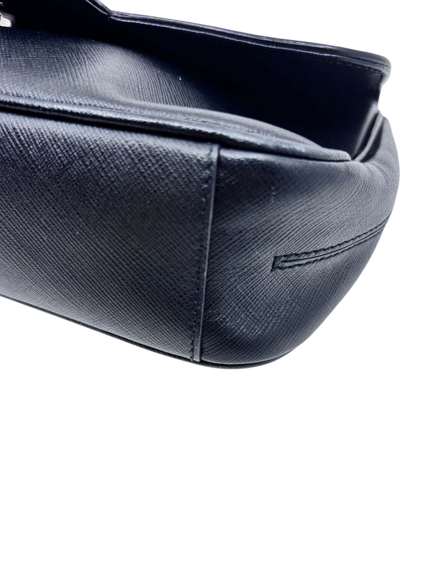 Close-up of the black textured leather base and side of a Posh Purse Co preloved Ferragamo shoulder bag.