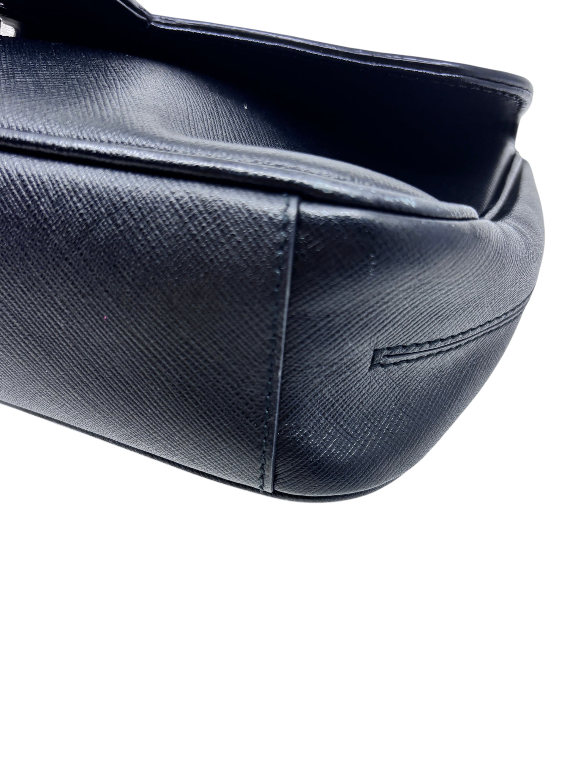 Close-up of the black textured leather base and side of a Posh Purse Co preloved Ferragamo shoulder bag.