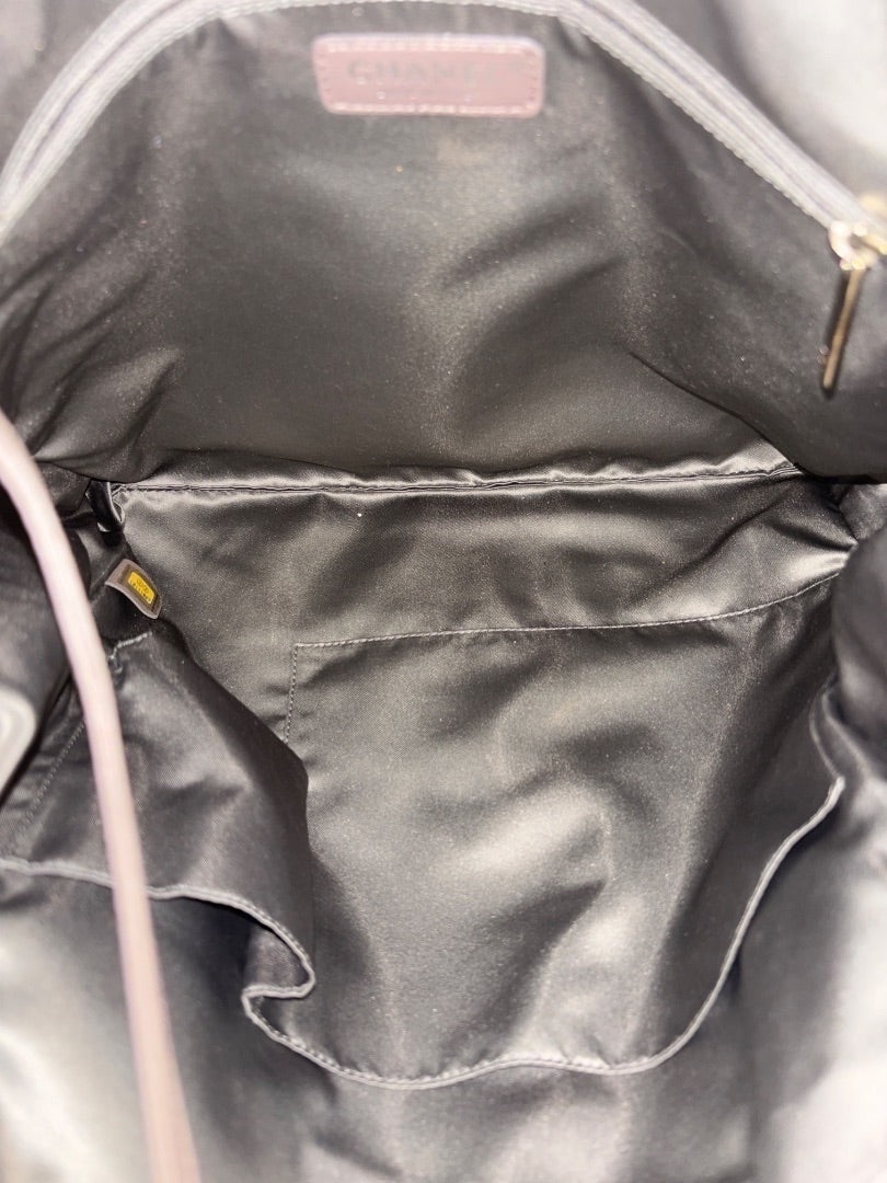 Posh Purse Co. Gold Chanel Drill Tote interior with pockets and Chanel logo tag.