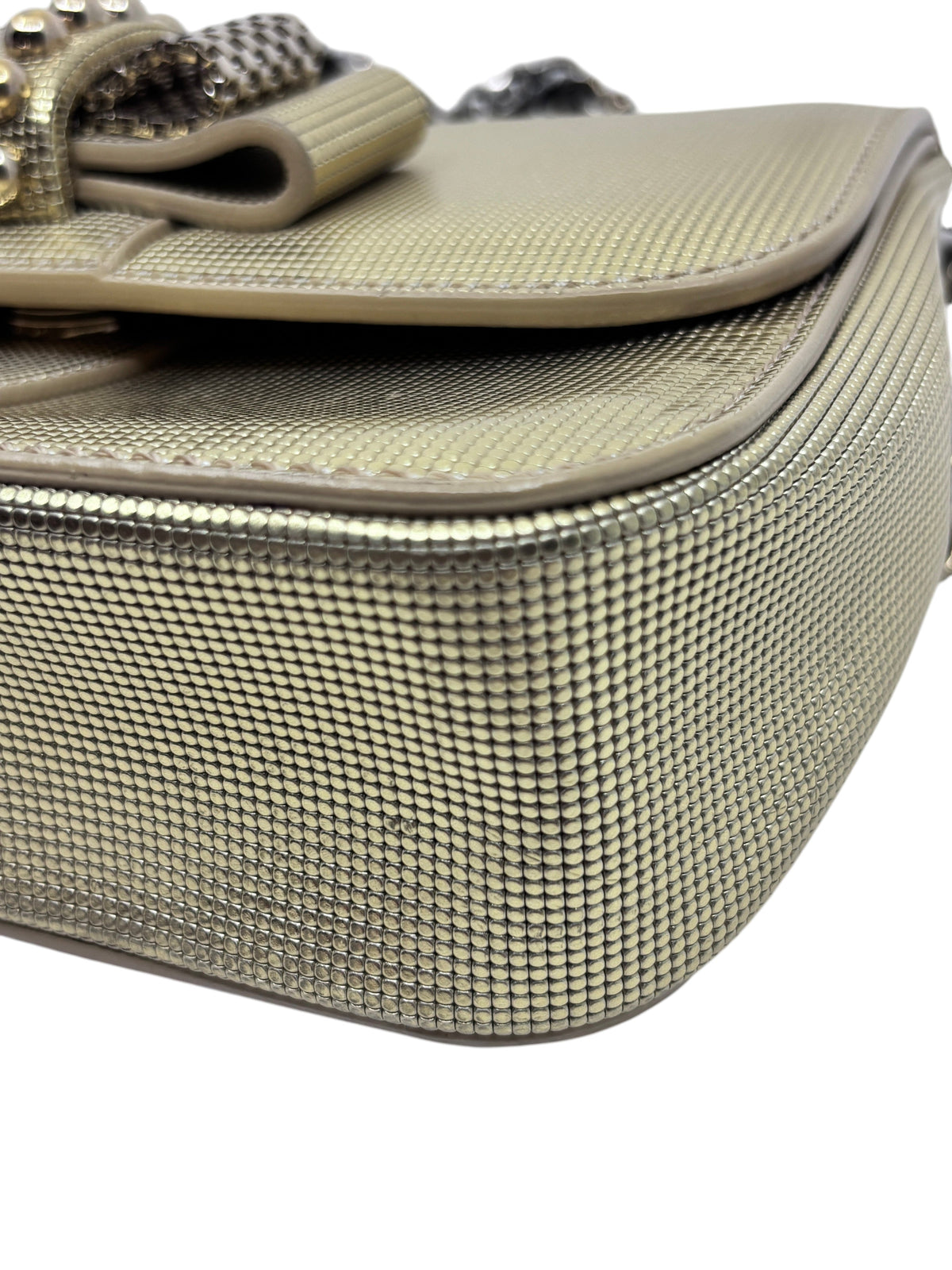 Posh Purse Co gold Christian Louboutin Sweet Charity backpack with textured metallic finish and bow detail