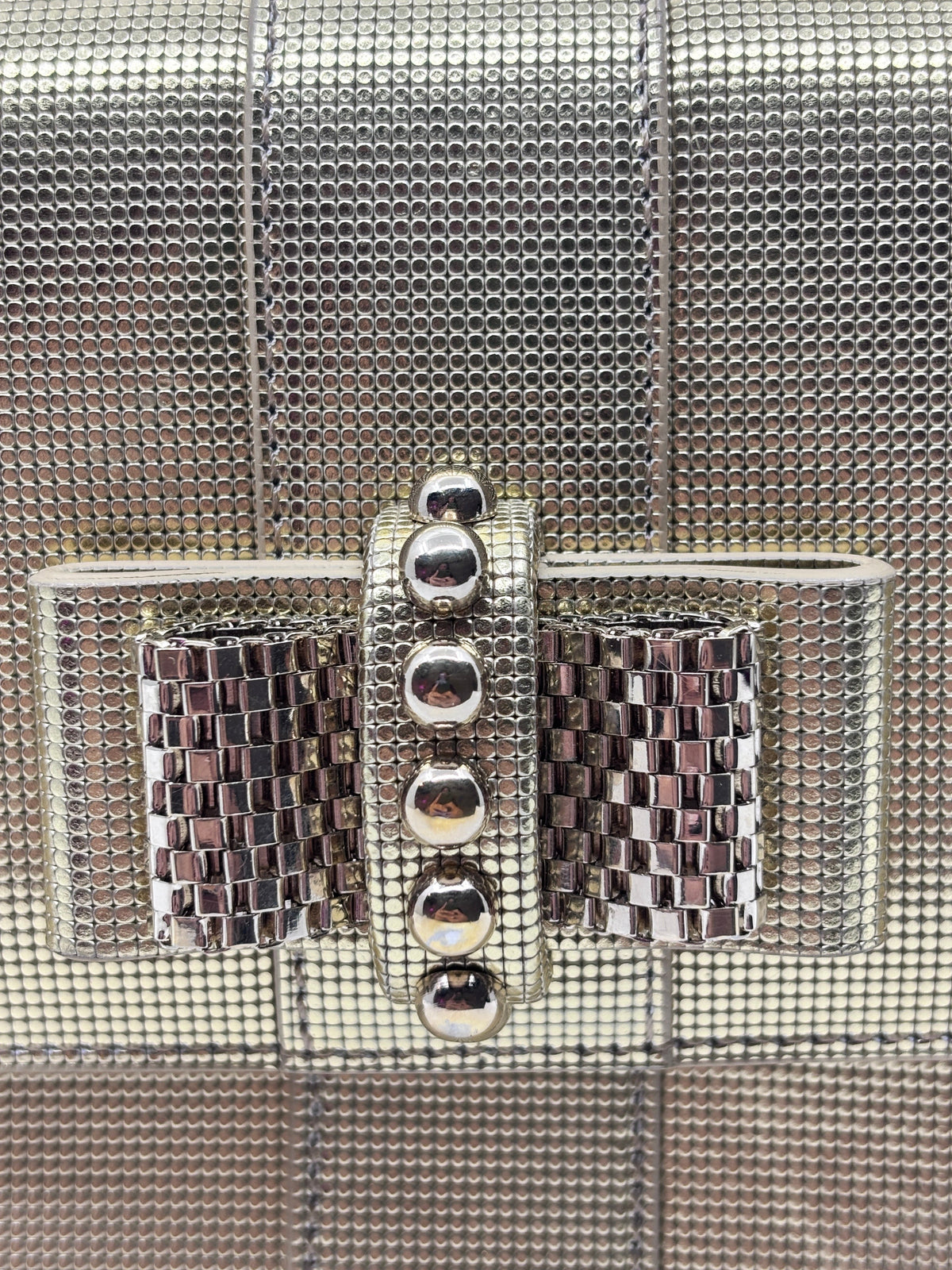 Posh Purse Co gold Christian Louboutin Sweet Charity backpack featuring a metallic studded bow and silver hardware.