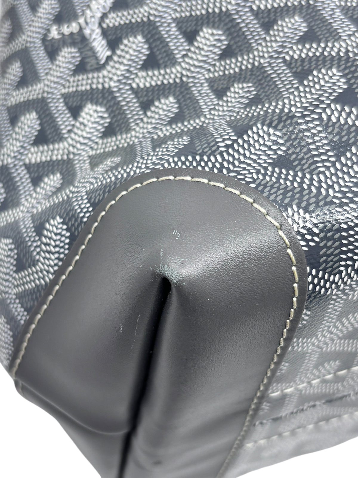 Posh Purse Co gray Goyard Bellechasse tote showing detail of the chevron coated canvas and leather corner trim