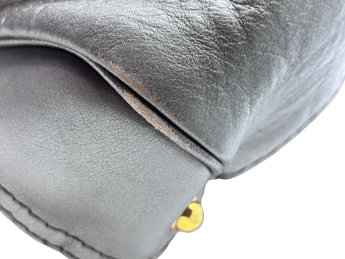 Close-up of Posh Purse Co. pre-owned gray leather Gucci Jockey shoulder bag showing corner wear and gold hardware