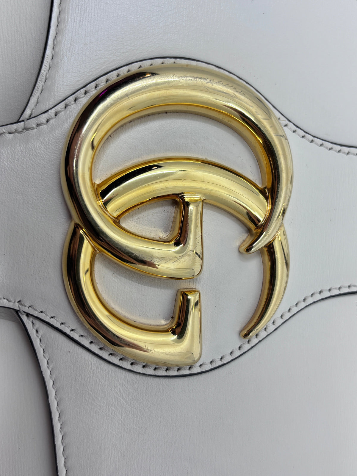 Posh Purse Co ivory Gucci Arli handbag featuring gold-tone Double G hardware with visible surface scuffs