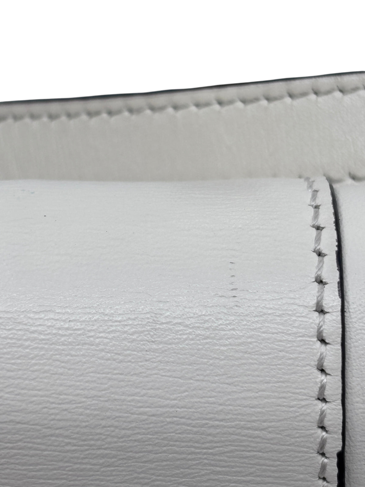 Close-up of ivory leather on a Posh Purse Co Gucci Arli bag showing minor surface marks and detailed stitching.