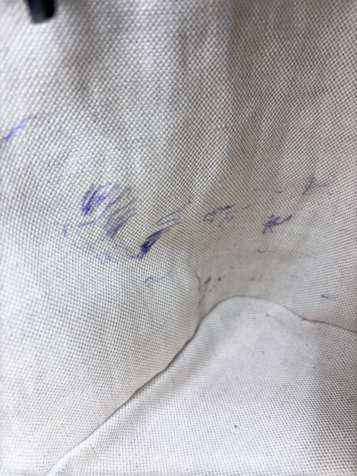 Interior lining of a Posh Purse Co preloved Gucci handbag showing visible blue ink pen marks on the fabric
