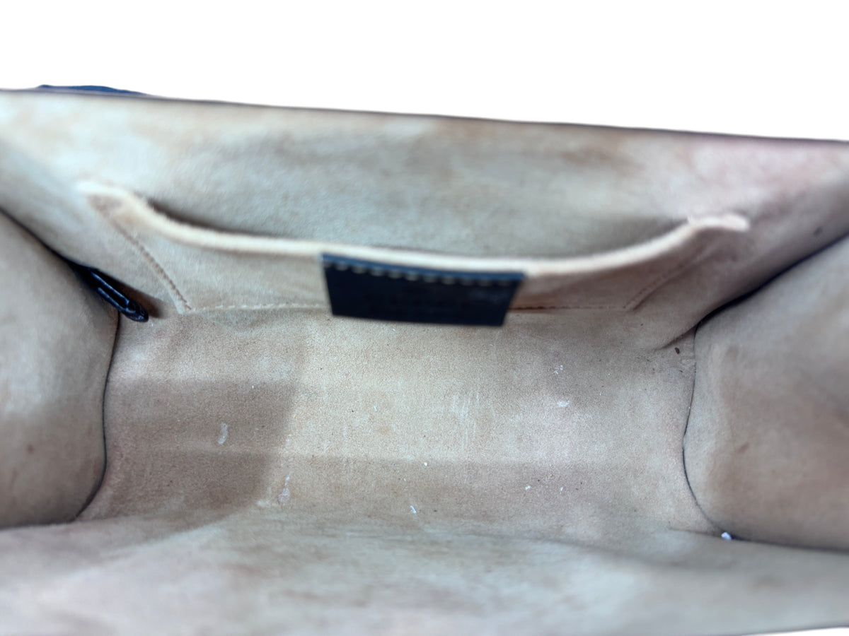 Interior view of a Posh Purse Co preloved black Gucci shoulder bag showing the beige suede lining and slip pocket.