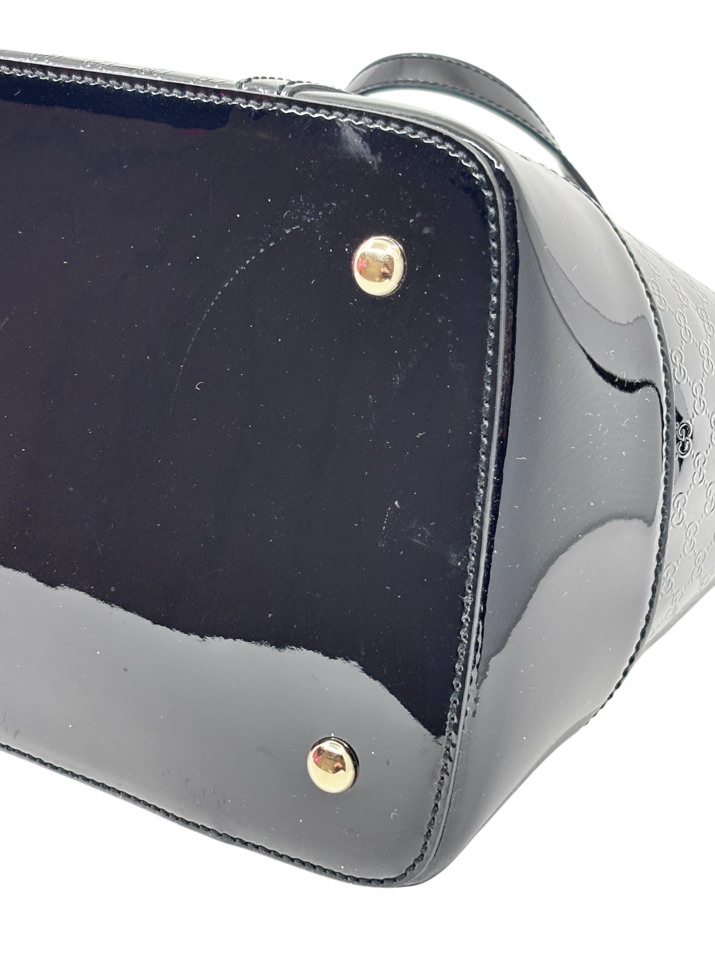 Posh Purse Co black Gucci Micro Guccissima leather handbag base with gold-tone protective feet
