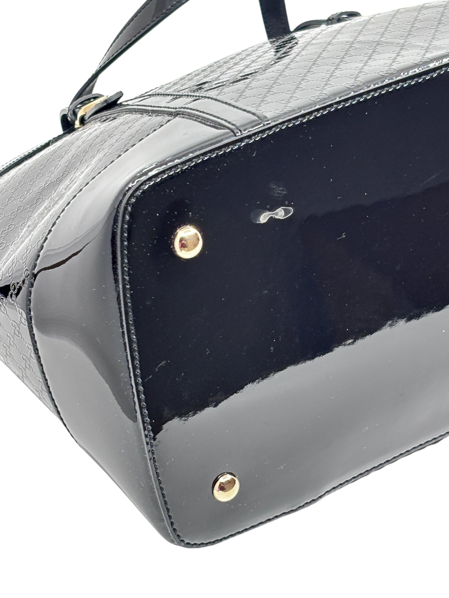 Posh Purse Co black Gucci Micro Guccissima leather handbag base with gold protective feet and embossed GG pattern
