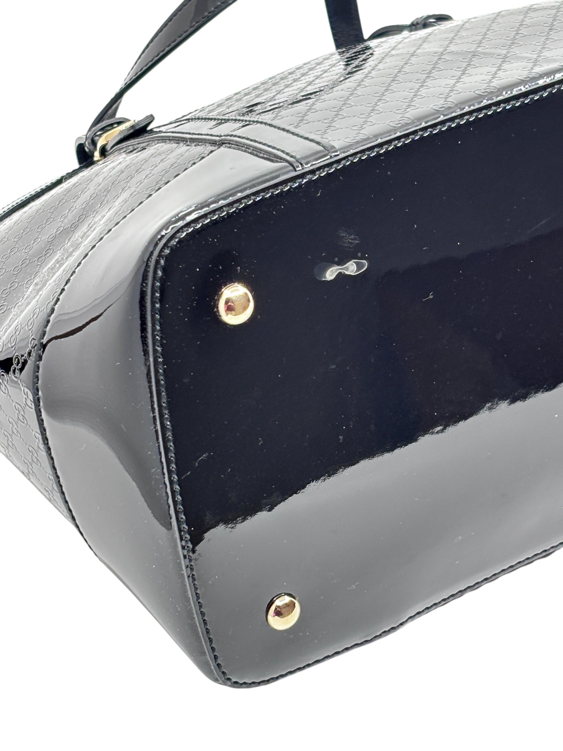 Posh Purse Co black Gucci Micro Guccissima leather handbag base with gold protective feet and embossed GG pattern