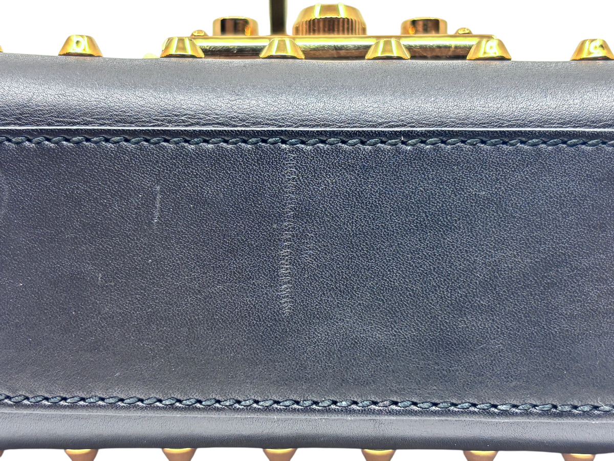 Posh Purse Co black Gucci shoulder bag showing leather exterior detail with gold hardware and minor surface scratch