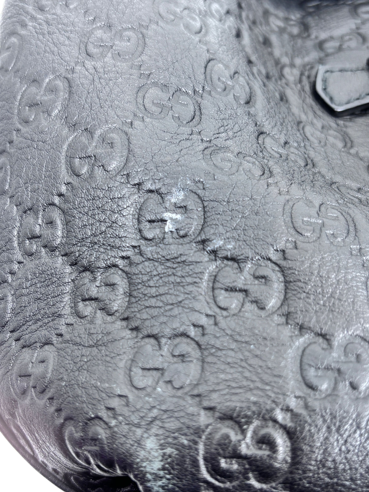 Posh Purse Co. black Gucci leather hobo bag with embossed GG monogram pattern and visible surface texture