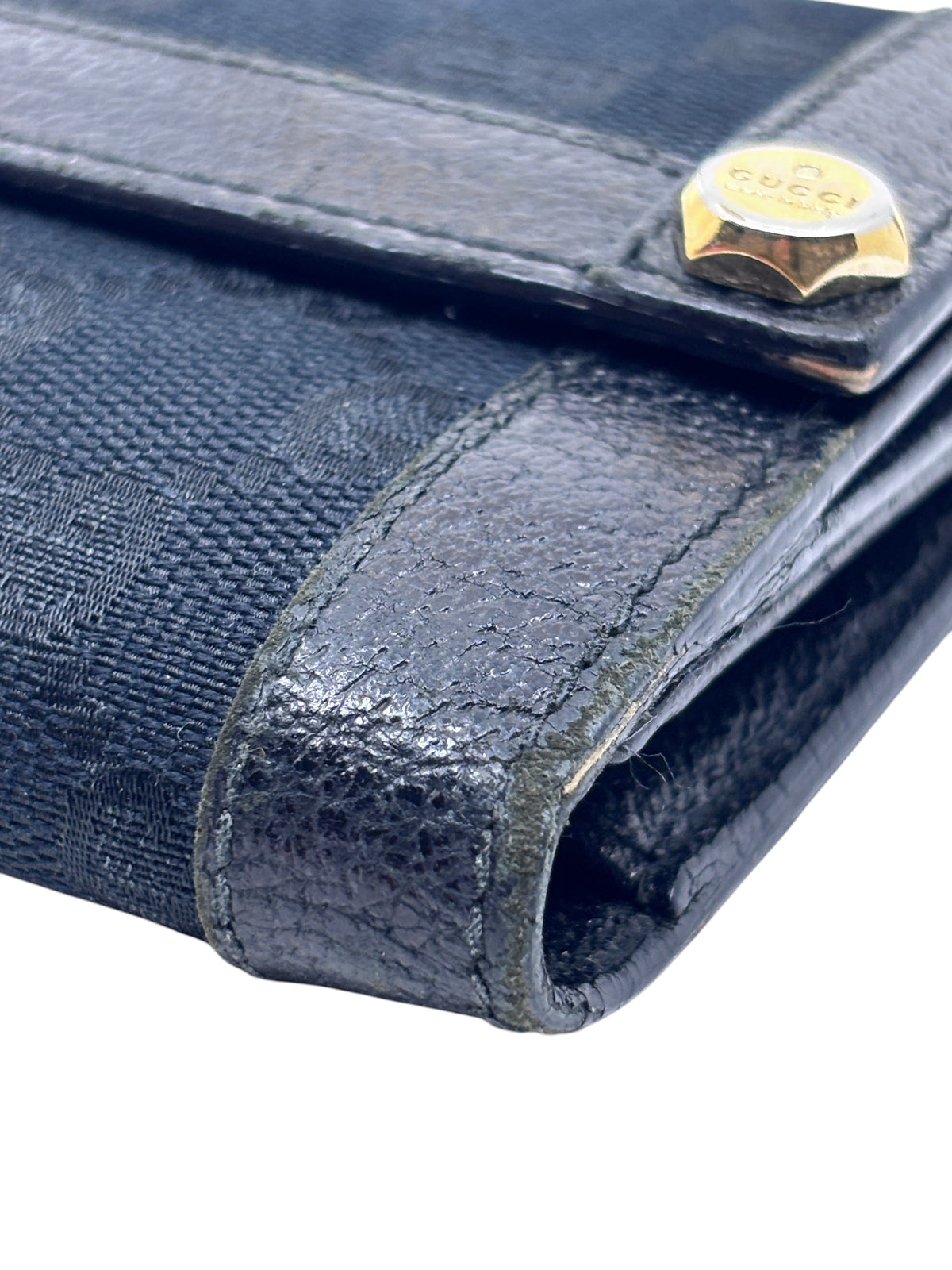 Posh Purse Co. preloved Gucci black continental wallet featuring signature canvas texture and gold-tone hardware detail