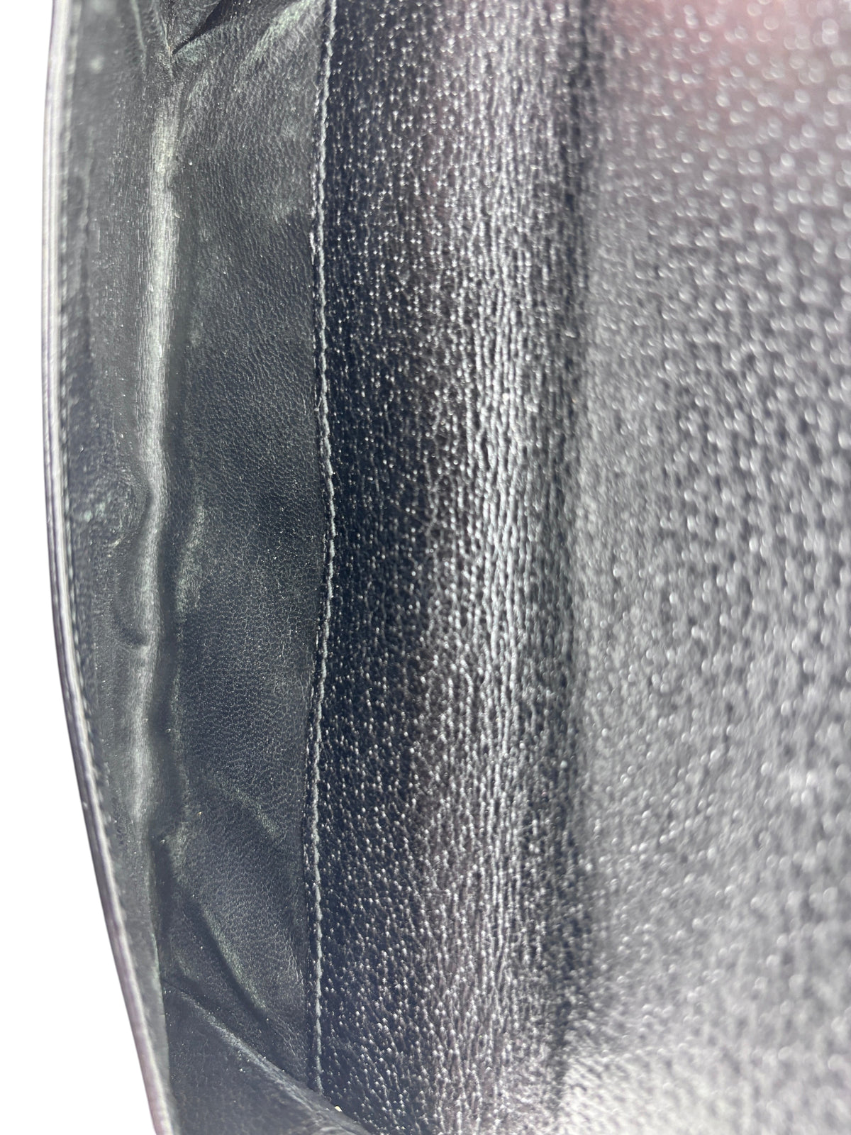 Interior view of a preloved black leather Gucci continental wallet from Posh Purse Co showing textured lining