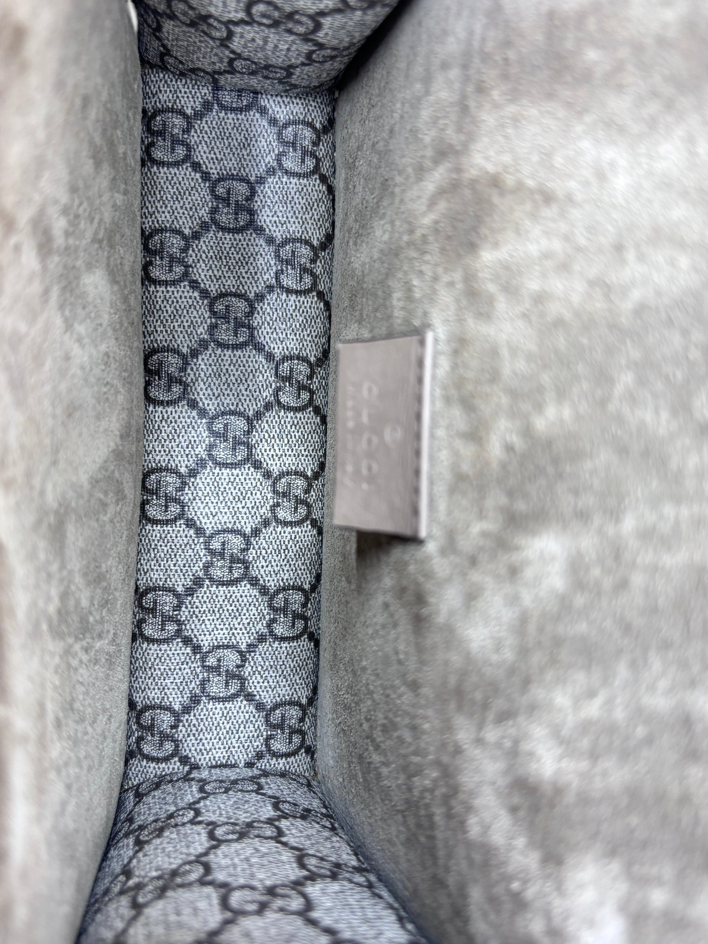Interior of Posh Purse Co preowned Gucci Dionysus small bag featuring grey GG monogram canvas and suede lining
