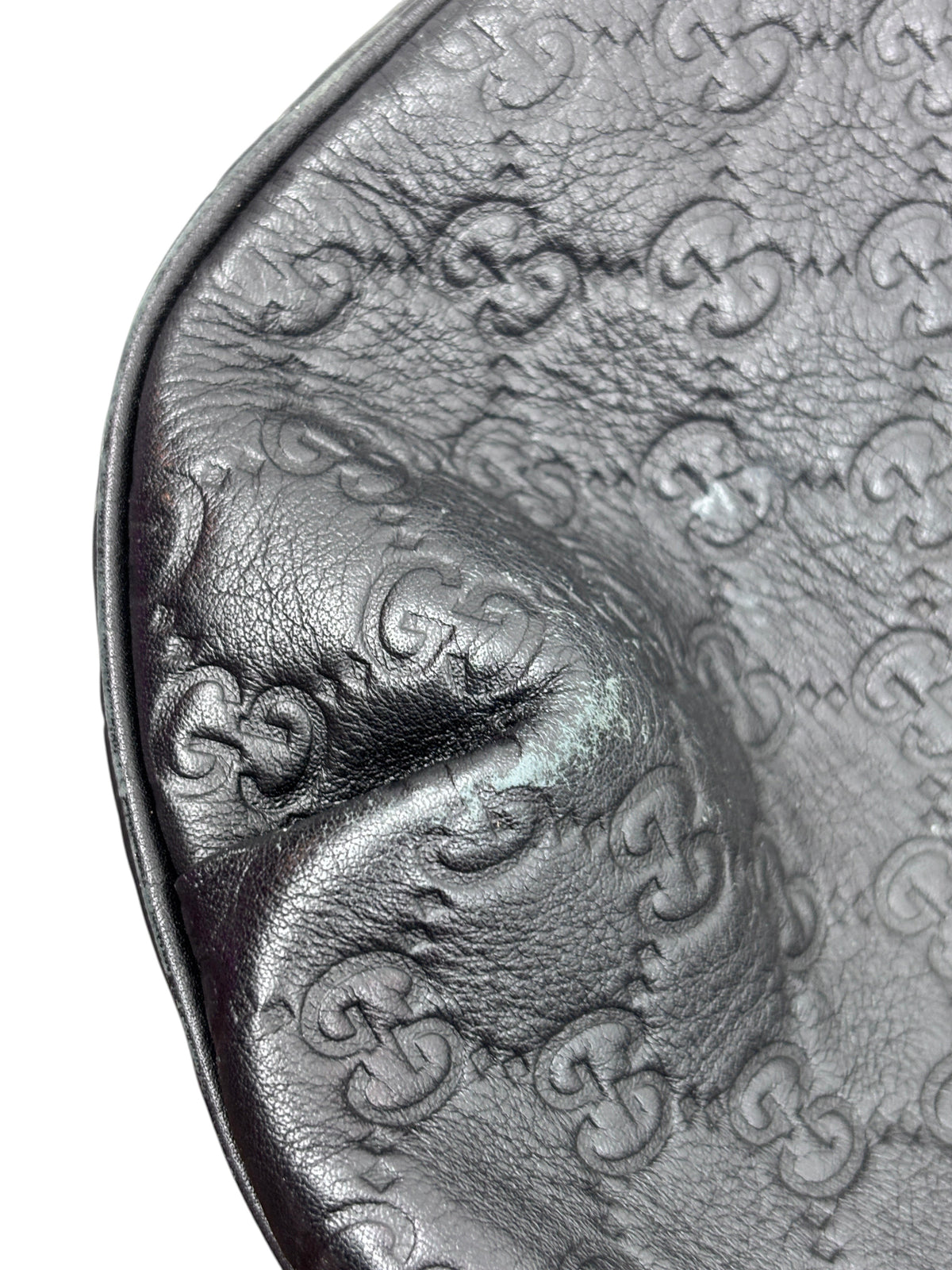 Close-up of Posh Purse Co. preloved black Gucci Horsebit 1955 hobo bag showing embossed GG leather texture and corner wear