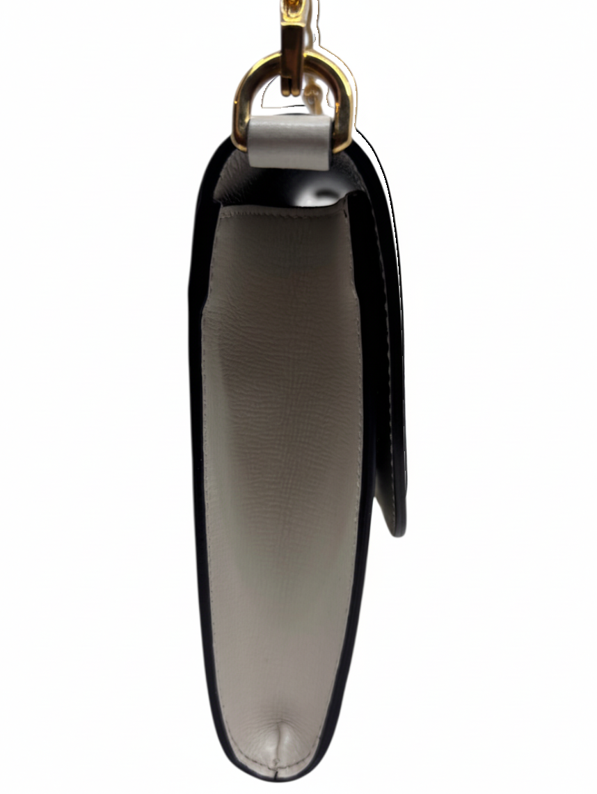 Side profile of a Posh Purse Co. Gucci Horsebit 1955 shoulder bag in white leather with gold hardware