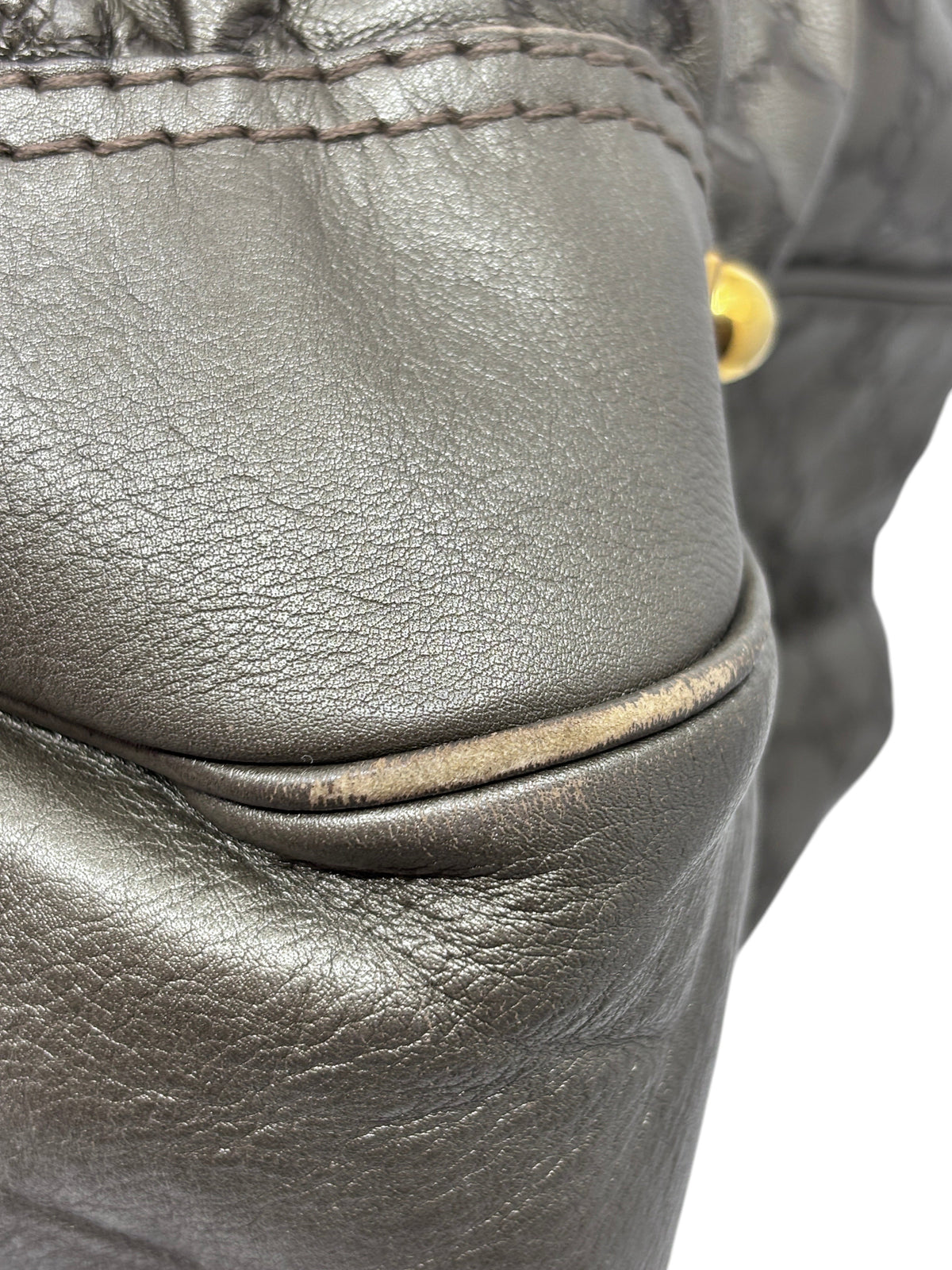 Close-up of corner wear on a gray leather Gucci Jockey shoulder bag from Posh Purse Co.