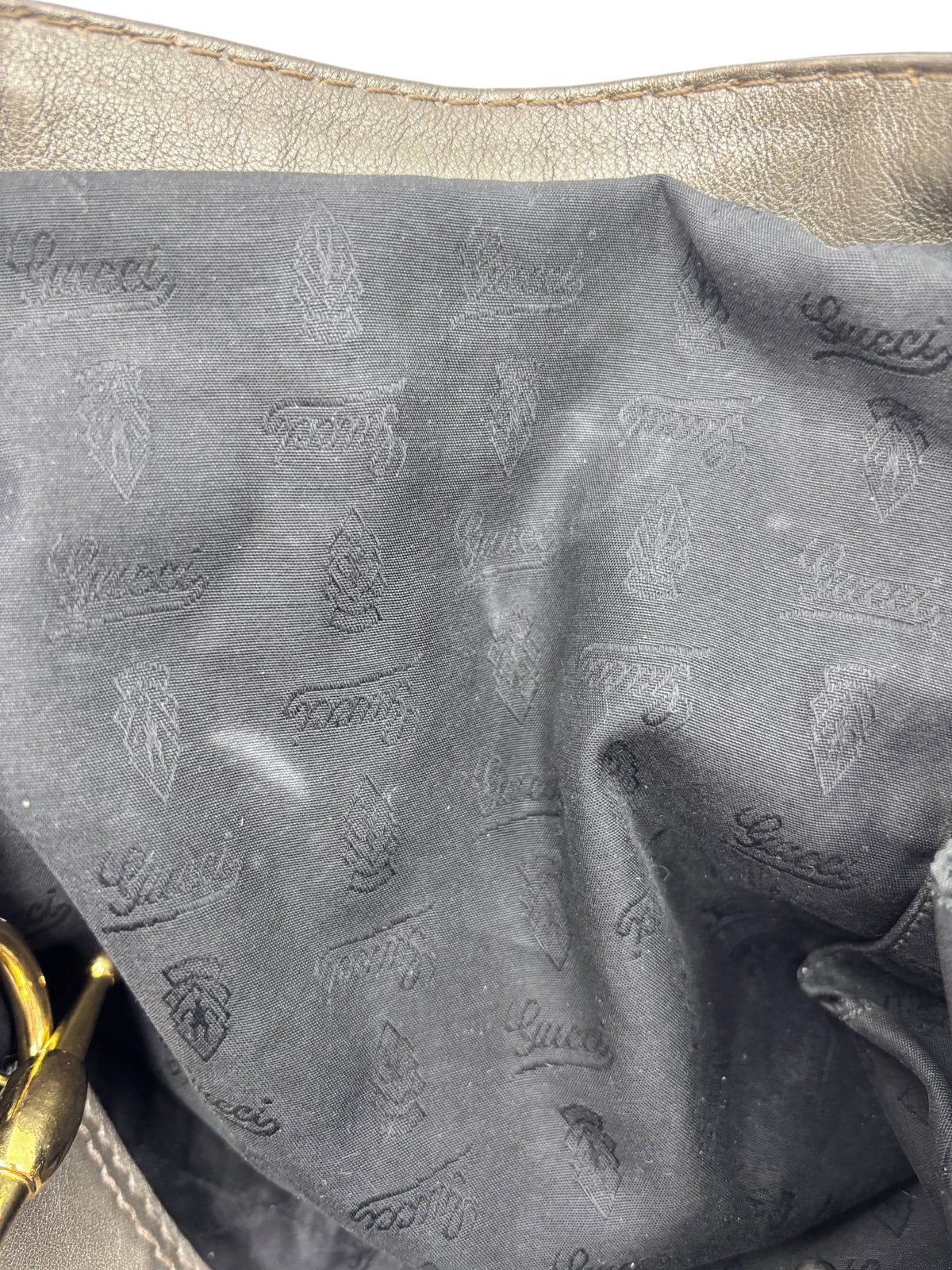 Interior lining of a Posh Purse Co. pre-owned gray Gucci Jockey shoulder bag with signature logo fabric