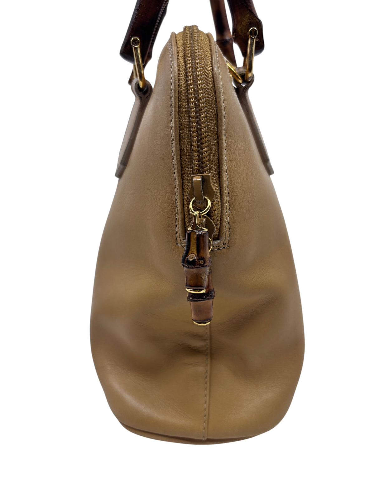 Posh Purse Co preloved Gucci leather satchel featuring a signature bamboo zipper pull and structured side profile.