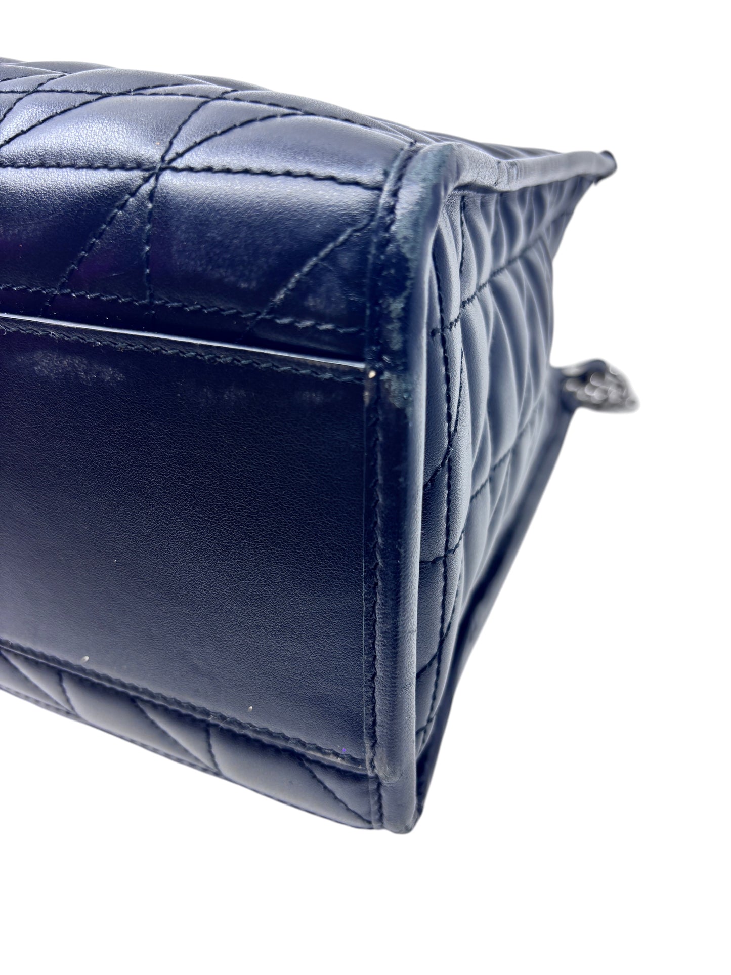 Close-up of the side panel of a black matelassé leather Gucci GG Marmont shoulder bag from Posh Purse Co.