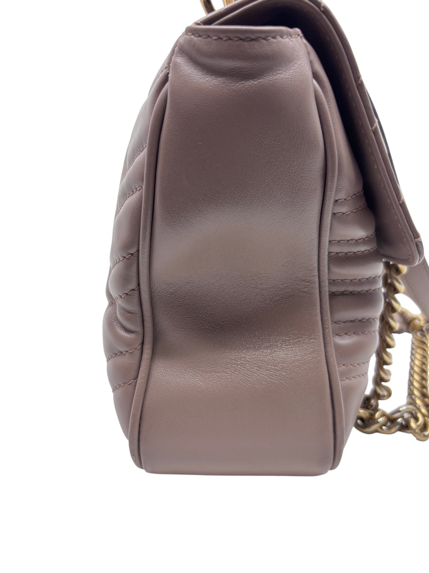 Side view of a beige quilted leather Gucci Marmont shoulder bag with gold chain strap from Posh Purse Co.