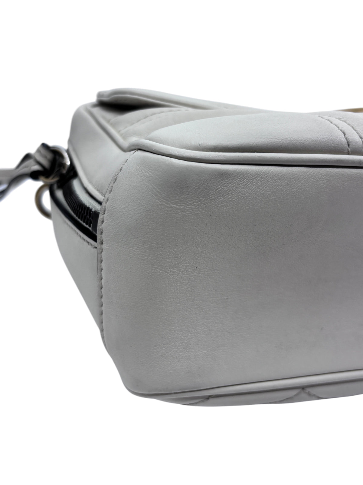 Posh Purse Co white leather Gucci GG Marmont camera bag side view showing quilted matelassé texture and stitching.