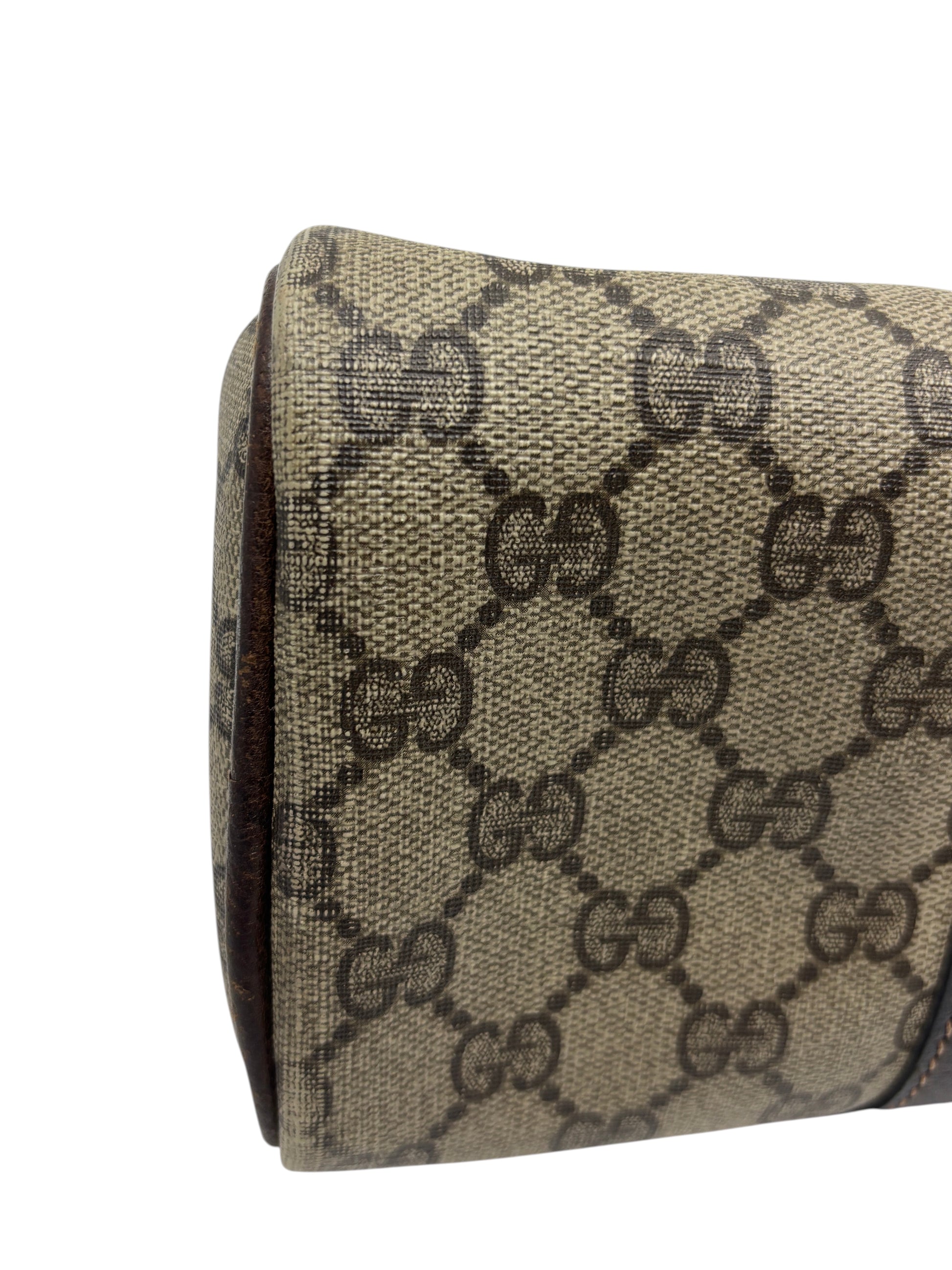 Close-up of the side panel of a vintage Posh Purse Co Gucci Boston bag featuring the iconic brown monogram canvas