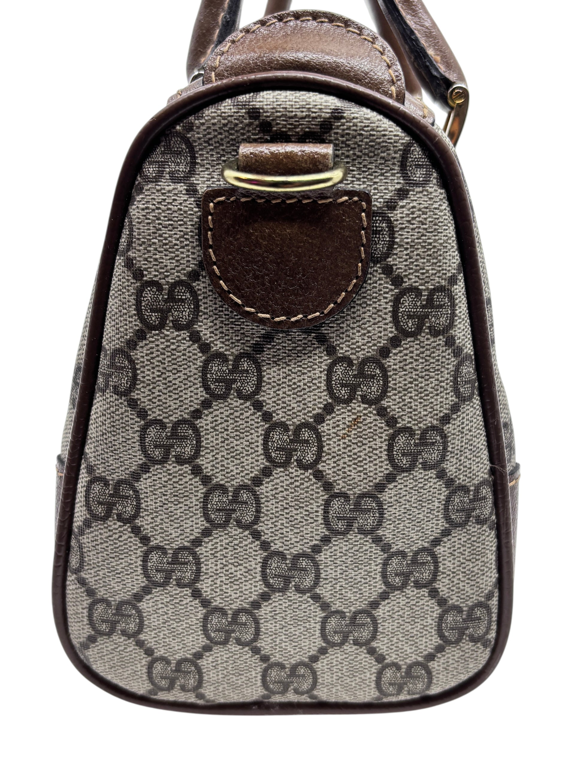 Side view of a vintage Posh Purse Co Gucci Boston bag featuring the iconic brown monogram canvas and leather trim