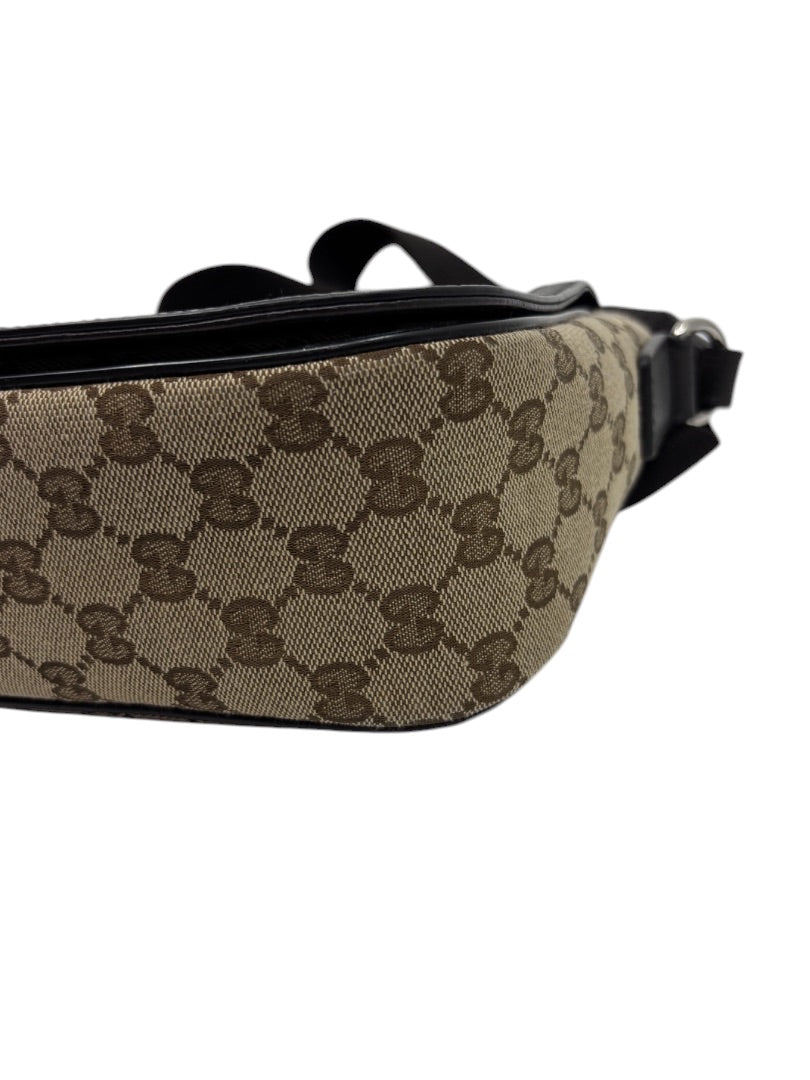 Posh Purse Co. preloved Gucci GG monogram canvas flap messenger bag in brown with black trim and adjustable strap.