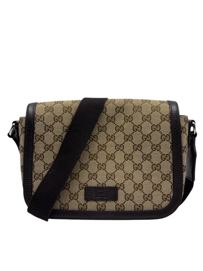 Posh Purse Co. preloved Gucci GG monogram canvas flap messenger bag with brown leather trim and adjustable strap.